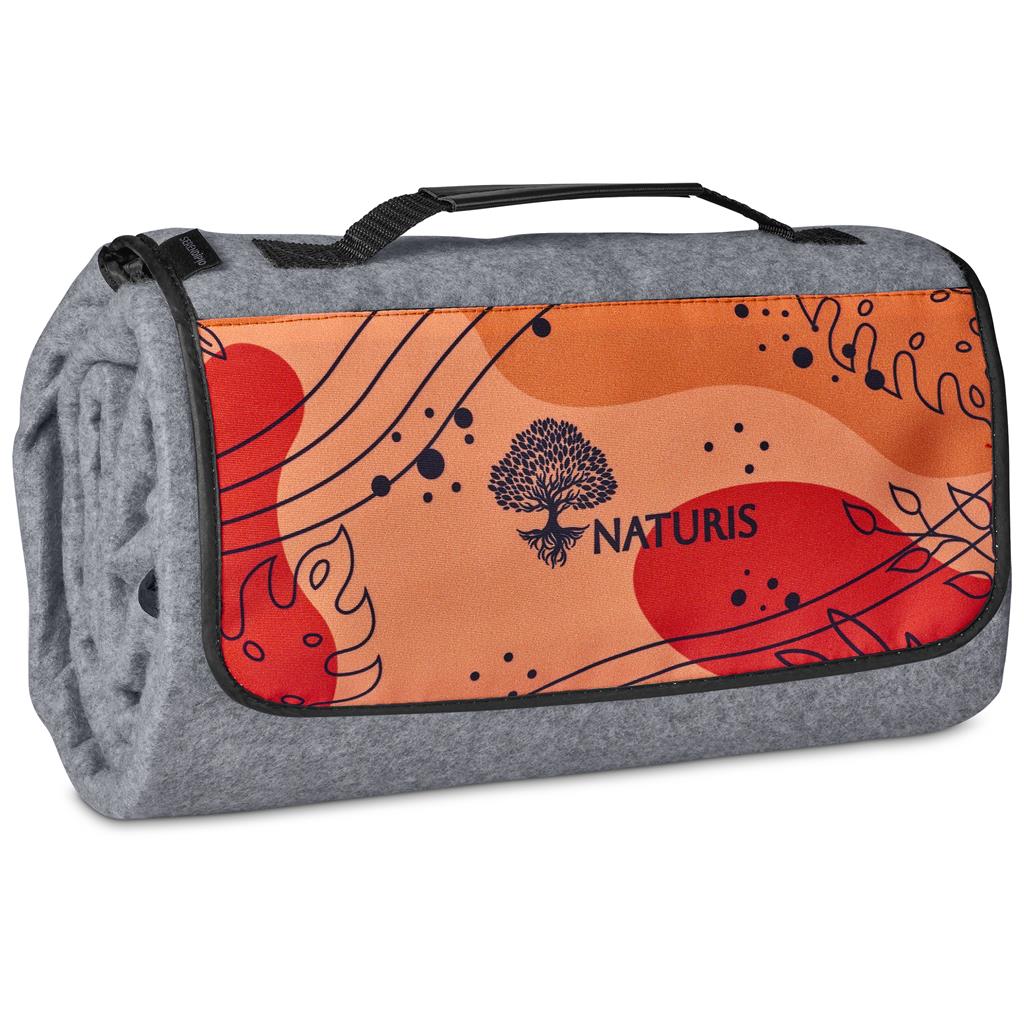 Roll-up picnic mat with orange design and 'Naturis' branding on a white background