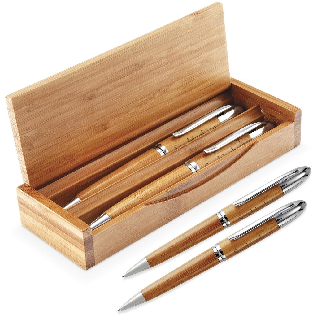 Set of wooden pens with silver accents in a bamboo box on a white background