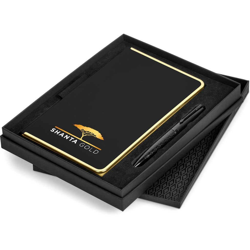 Black notebook with gold accents and a pen in a black box, featuring 'Shanta Gold' branding.

