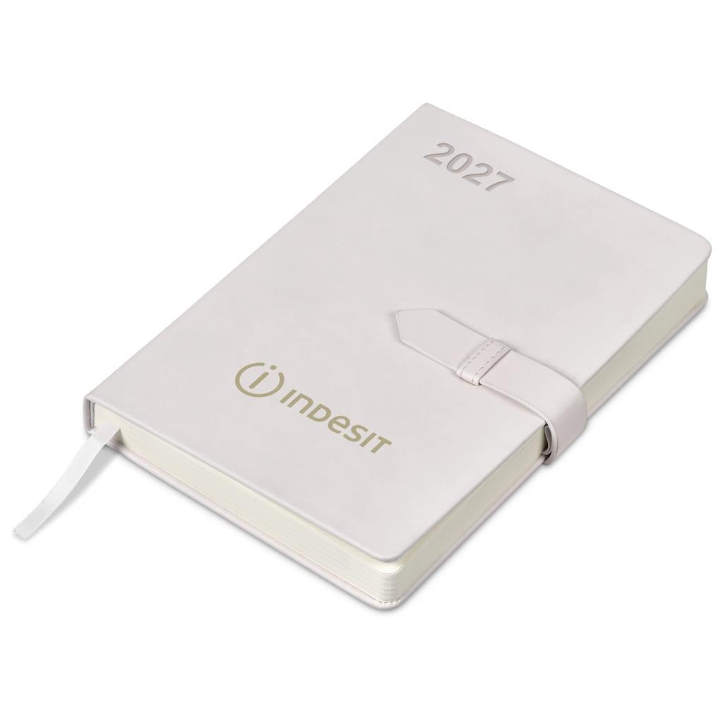 A white hardcover 2027 daily planner by Indesit, featuring a matching elastic closure strap and a white ribbon bookmark, shown on a clean white background.

