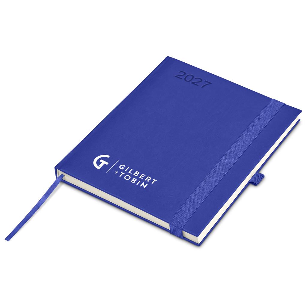 A blue hardcover 2027 daily planner by Gilbert + Jobin, featuring a matching blue elastic band closure and ribbon bookmark, displayed on a clean white background.


