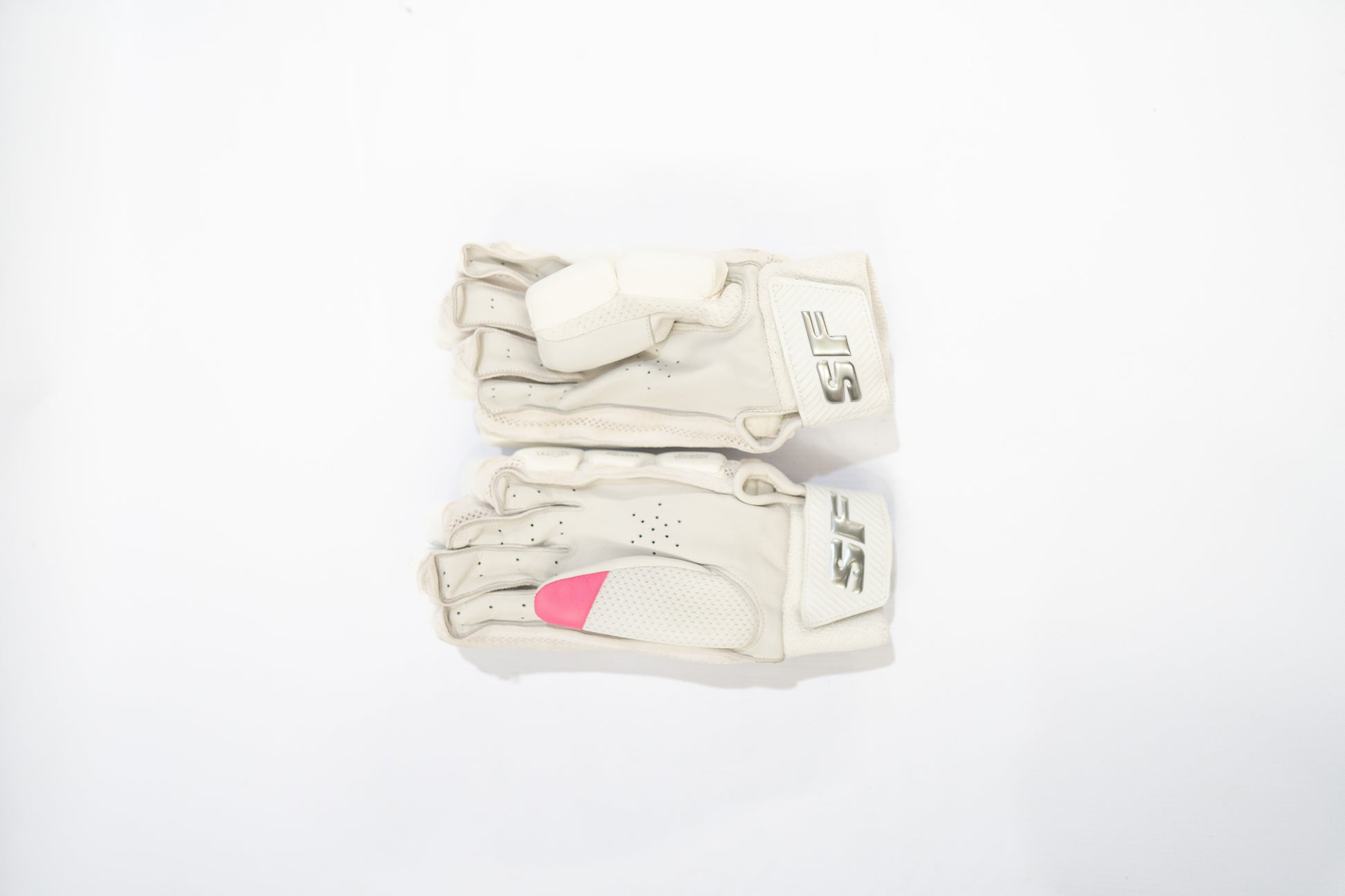 White batting gloves with pink heart design on a white background

