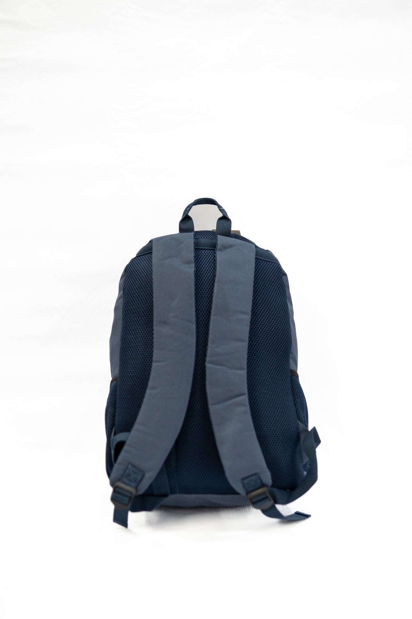 Back view of a blue backpack on a white background

