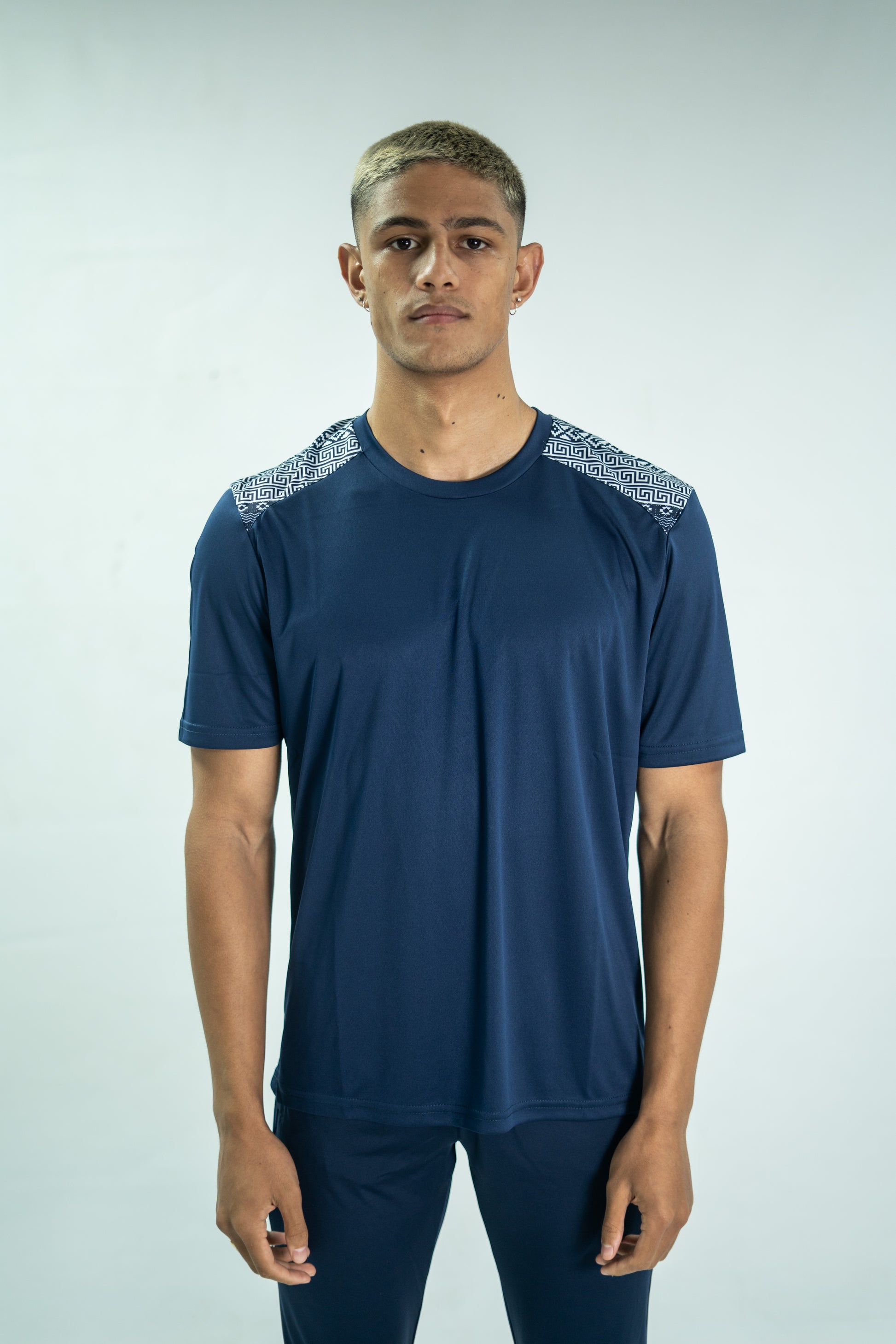 Person wearing a blue athletic outfit with decorative elements on a white background

