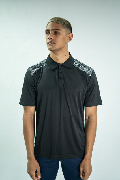 Man wearing a black polo shirt with patterned shoulders on a white background

