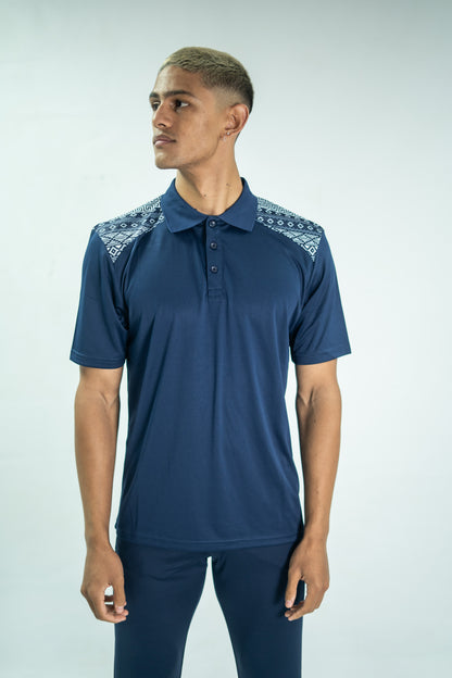 Man wearing a navy blue polo shirt with lace details on a light gray background

