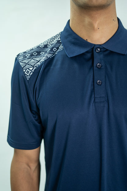 Navy blue polo shirt with patterned shoulder on a plain background

