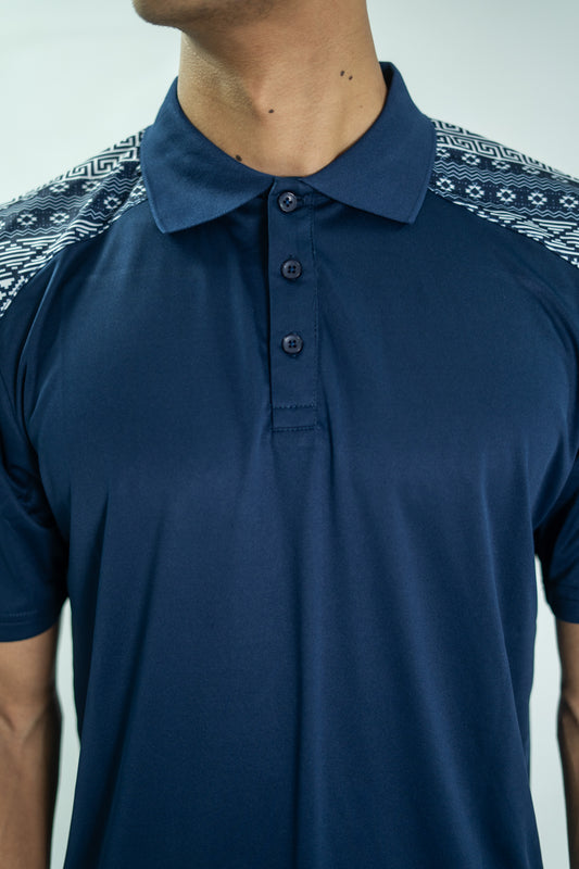 Navy blue polo shirt with patterned shoulders on a plain background

