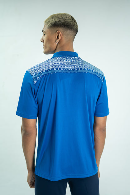 Man wearing a blue polo shirt with patterned collar on a white background

