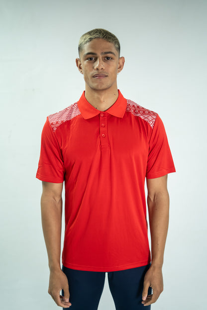 Man wearing a red polo shirt with white embroidery on a plain background

