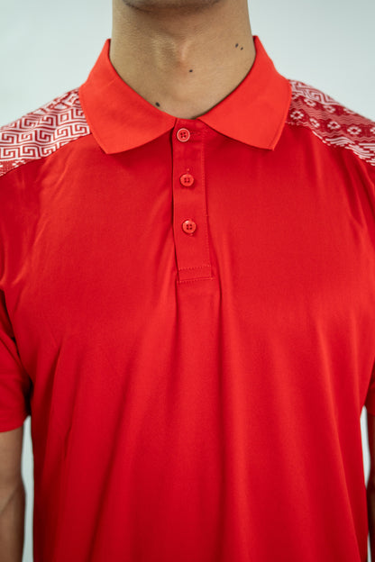 Red polo shirt with patterned shoulders on a plain background

