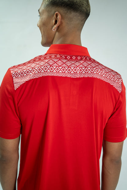 Red polo shirt with white pattern on collar worn by a person against a light gray background

