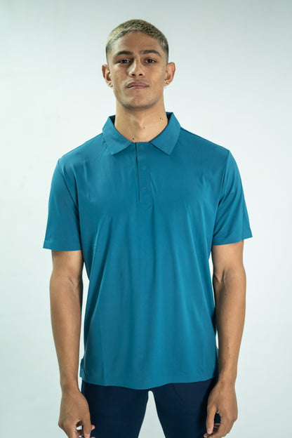 Man wearing a teal polo shirt against a white background

