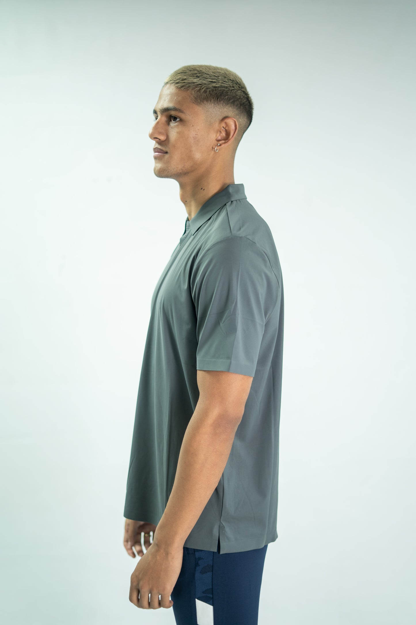 Man wearing a gray short-sleeve shirt on a light gray background

