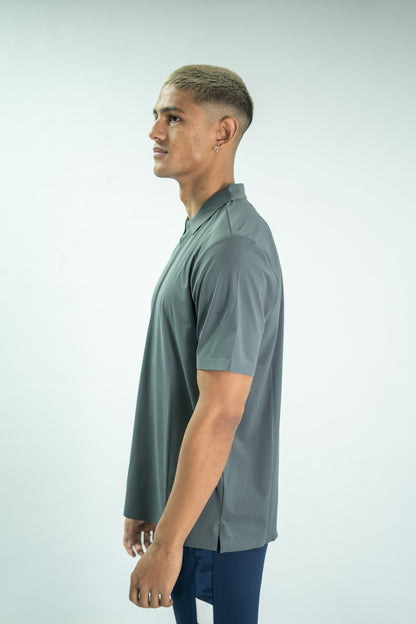 Man wearing a gray short-sleeve shirt on a light gray background

