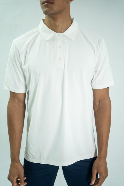 Person wearing a white polo shirt against a light gray background

