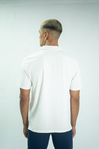 Man wearing a white polo shirt on a plain background

