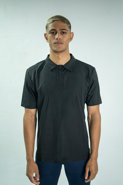 Man wearing a black polo shirt against a white background

