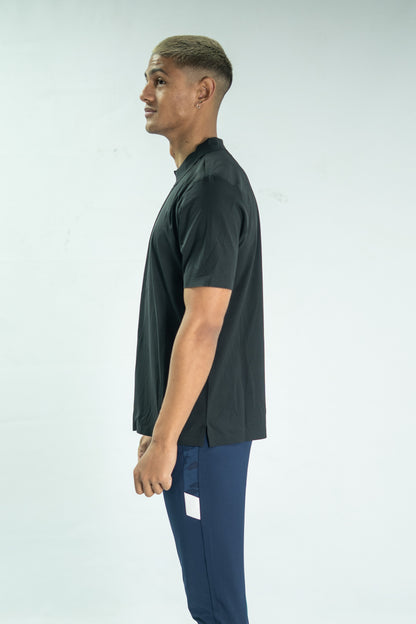 Man wearing a dark green t-shirt and blue pants on a white background

