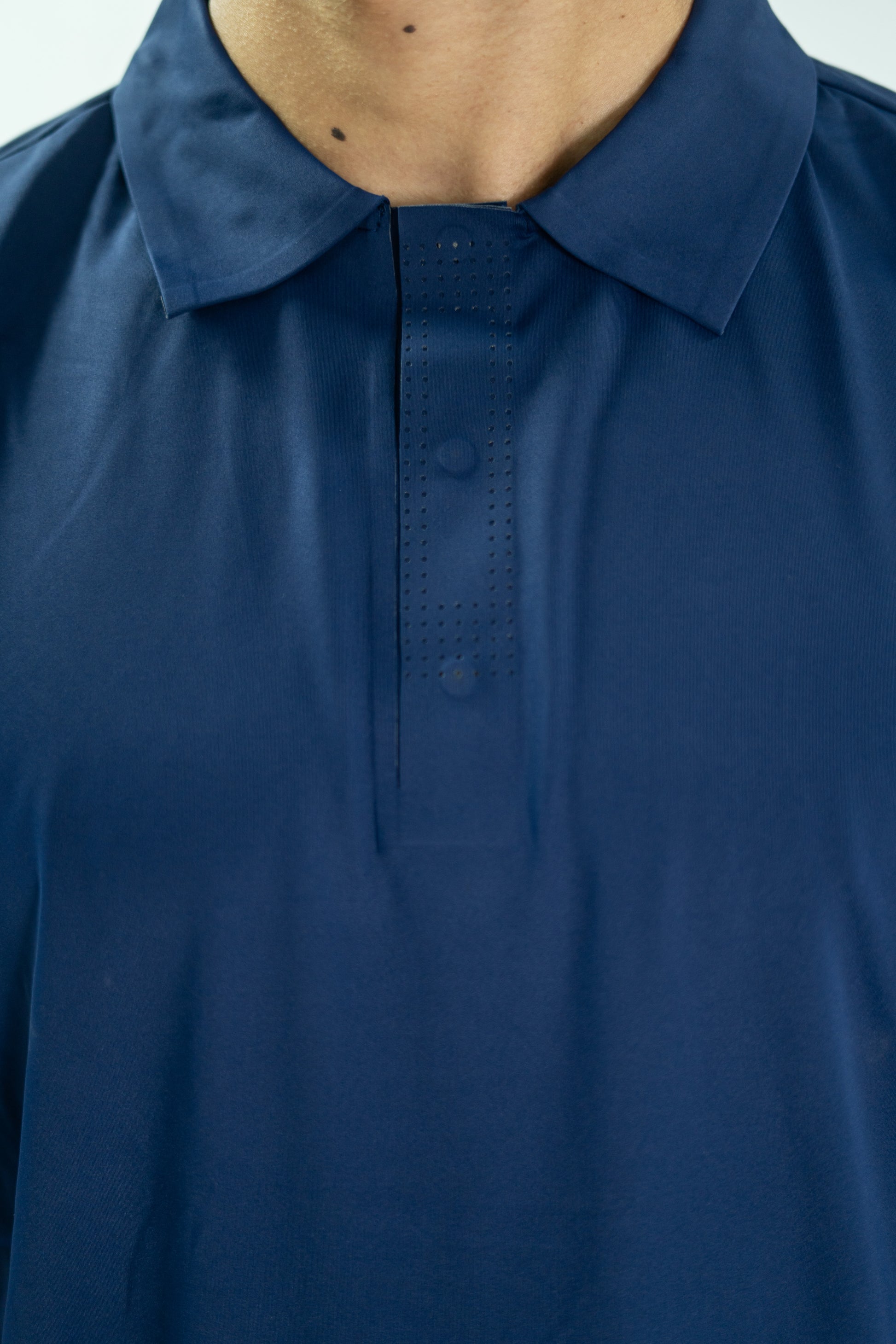 Close-up of a blue shirt with a collar on a plain background

