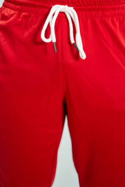 Red pants with a white drawstring on a light gray background

