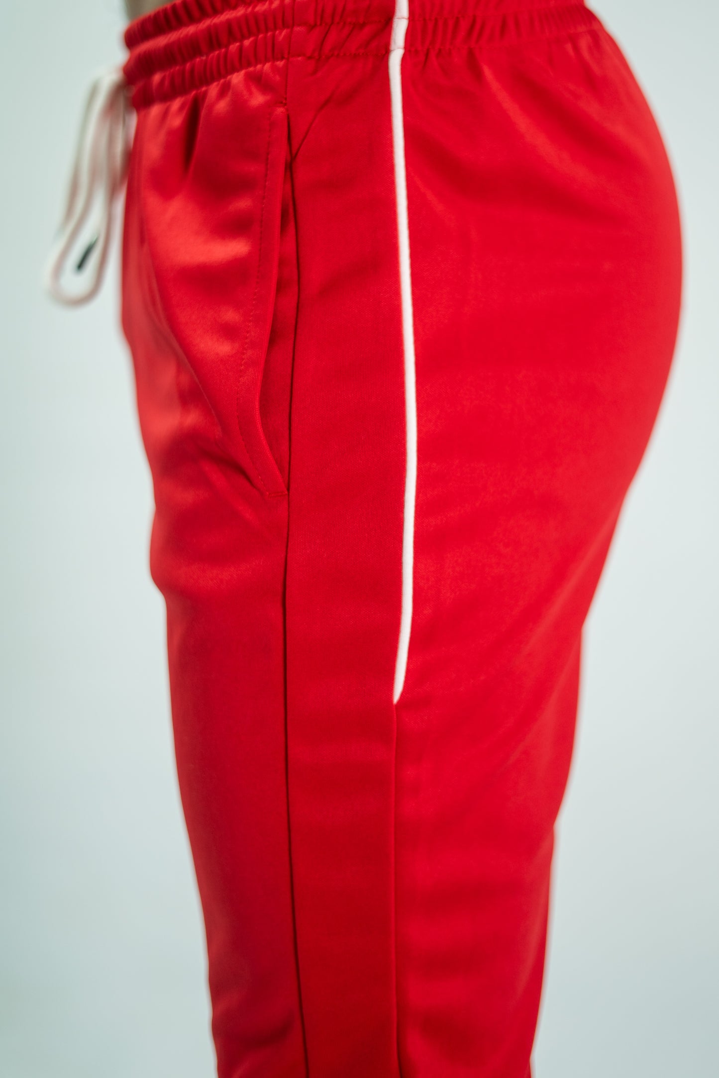 Red pants with a white stripe on a light gray background

