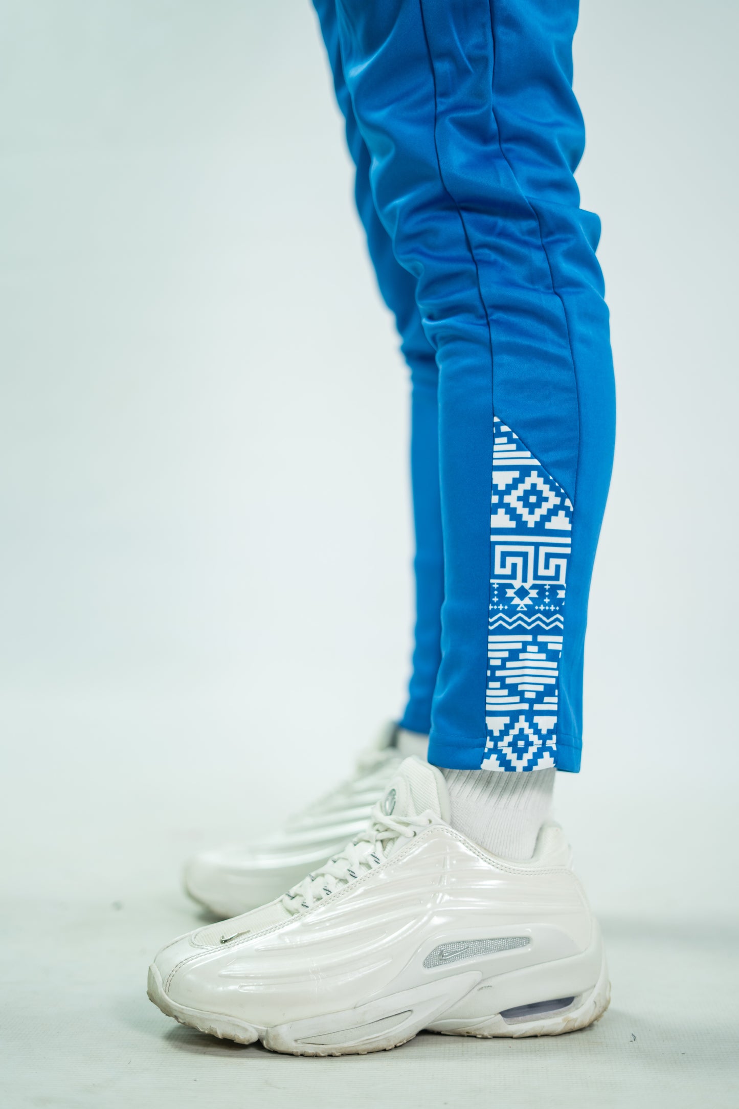 Blue tracksuit with geometric pattern on a white background

