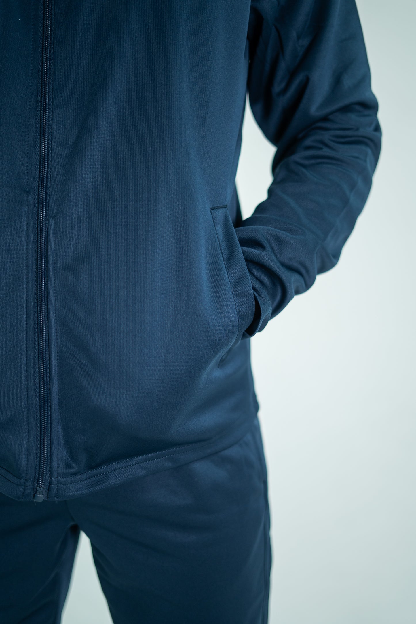 Navy blue tracksuit on a light gray background

