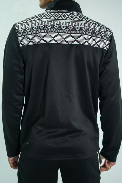 Black jacket with white geometric pattern on the back against a light gray background

