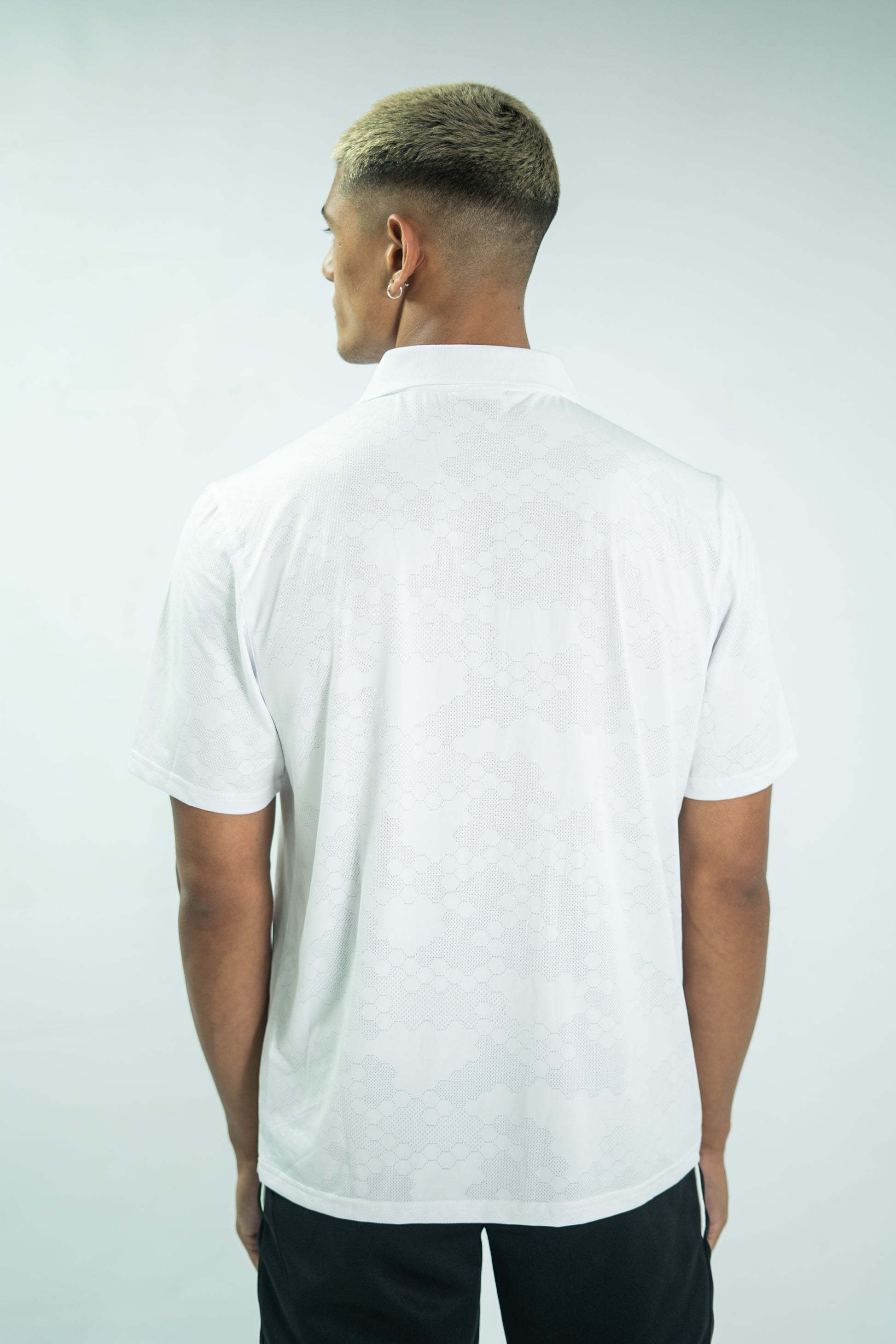 Person wearing a white t-shirt on a plain background

