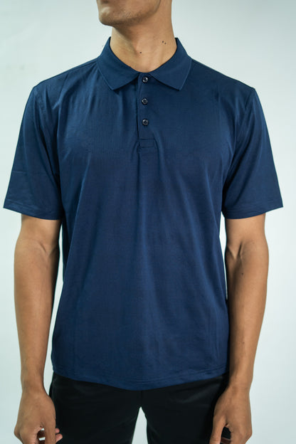 Person wearing a blue polo shirt against a plain background

