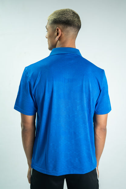 Person wearing a blue polo shirt against a white background

