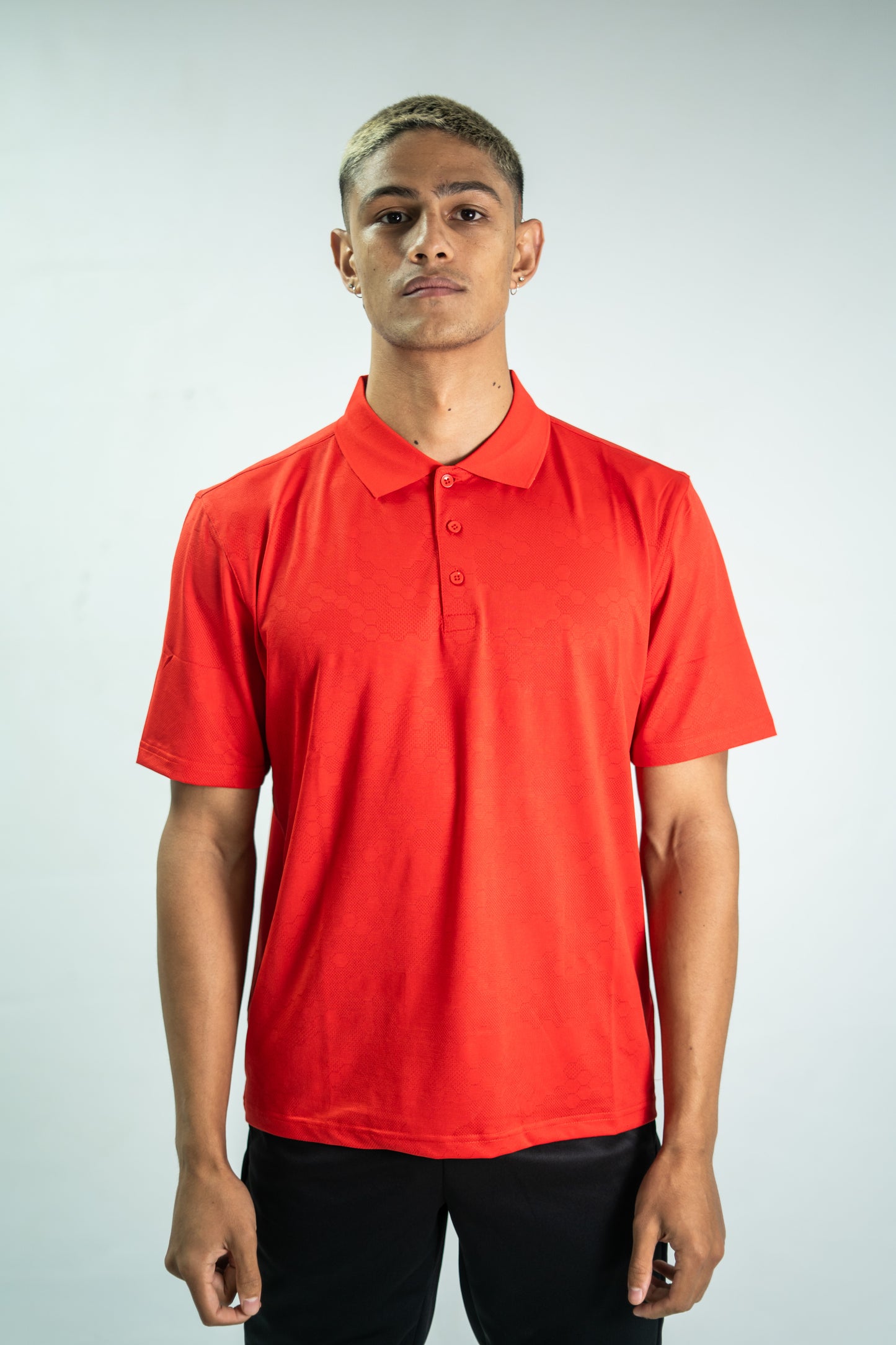 Person wearing a red polo shirt against a plain background


