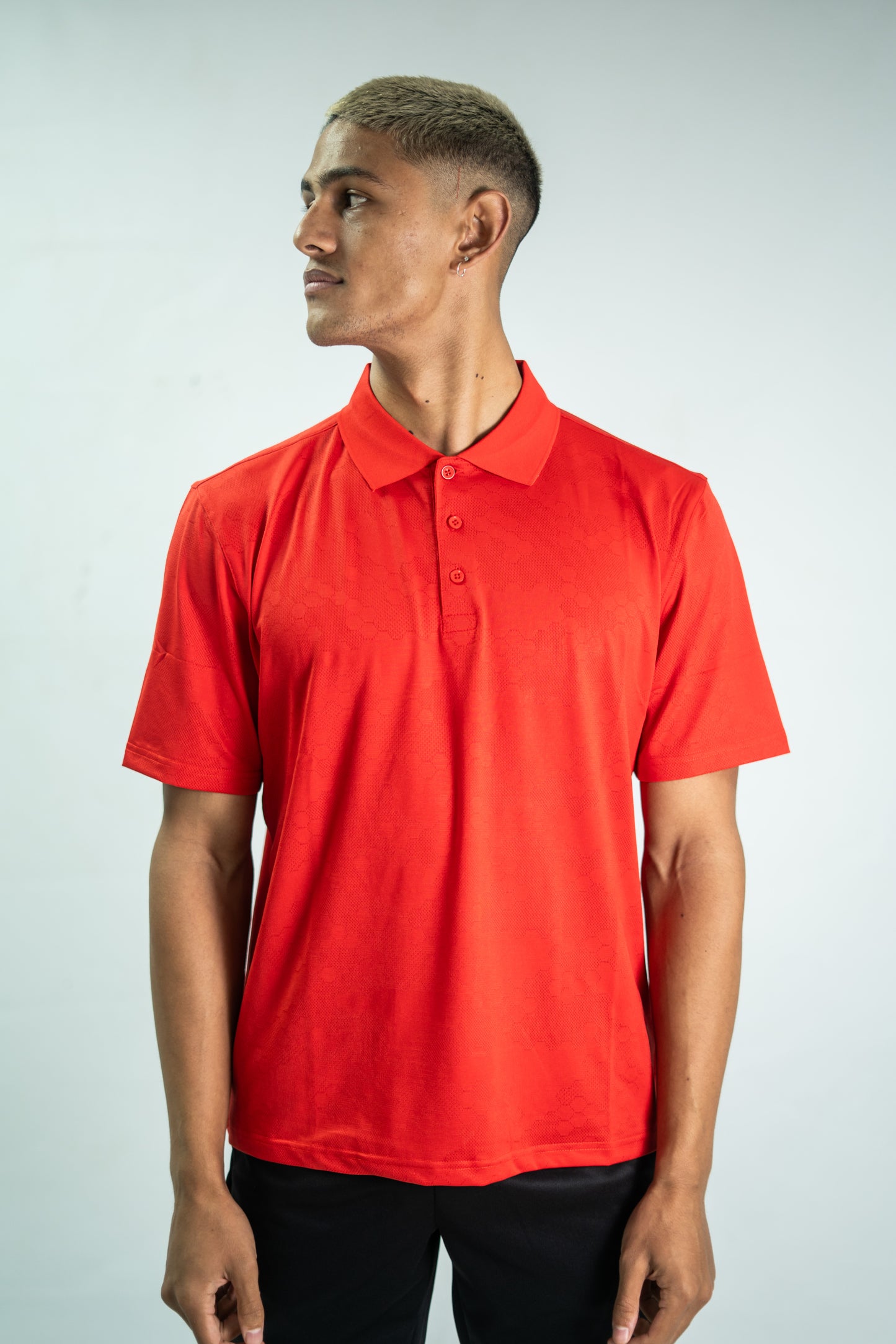 Man wearing a red polo shirt against a plain background

