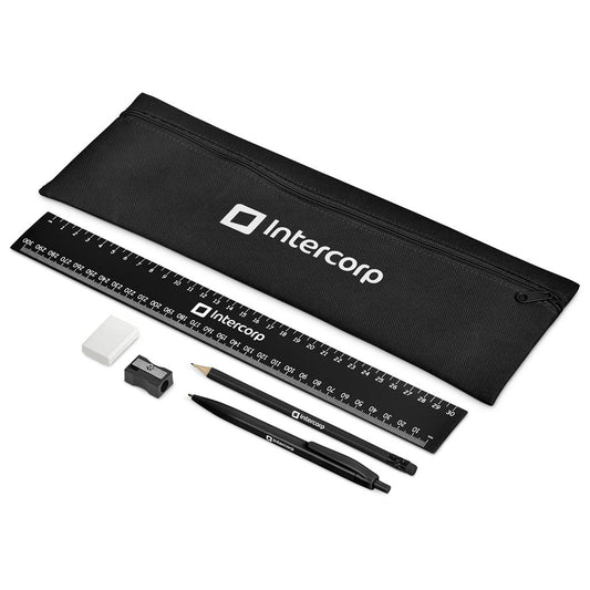 Black stationery set with ruler, pencil, eraser, and sharpener on a white background, featuring the Intercorp logo.

