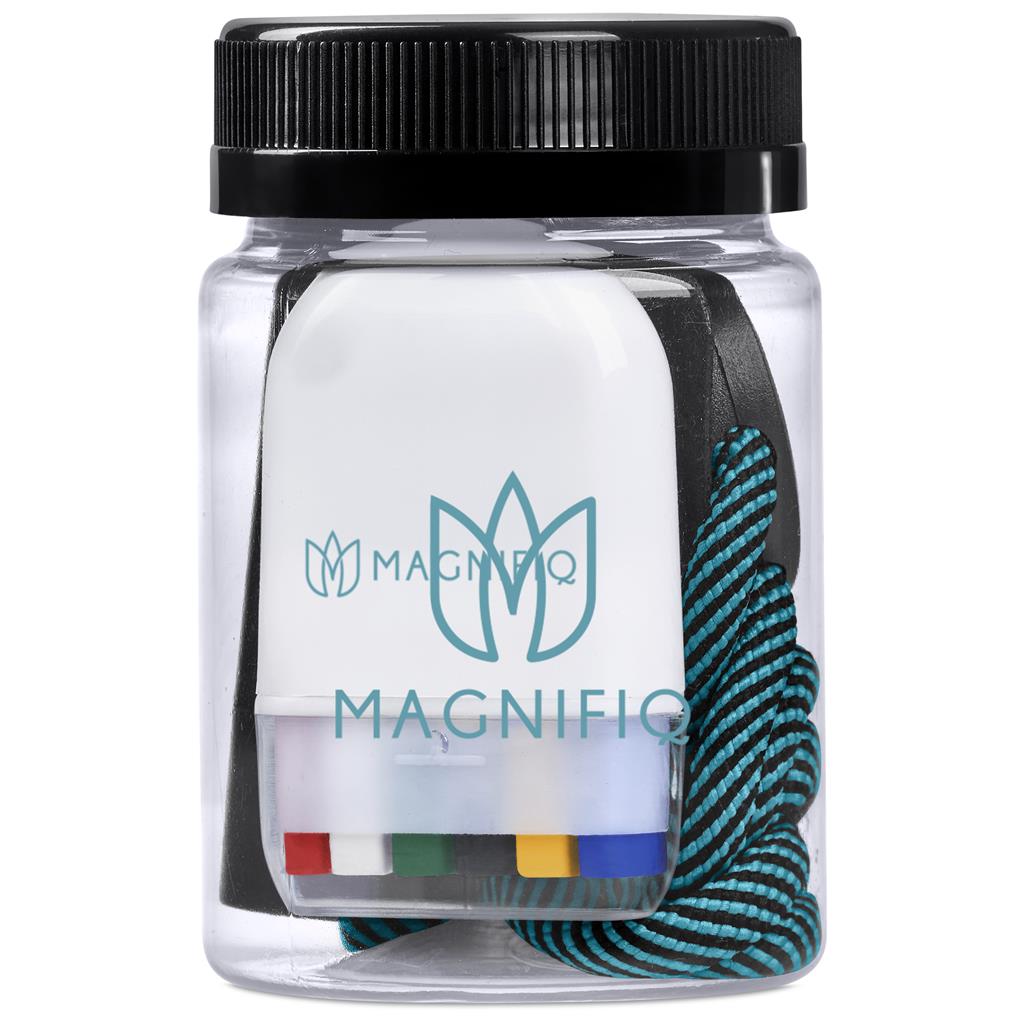 Clear container with black lid containing colorful markers and a blue hair tie, branded 'Magnifico'.

