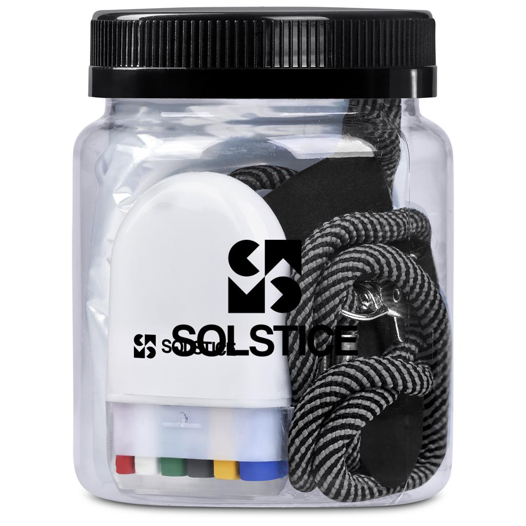 Clear container with black lid containing earbuds and a keychain, branded 'Solstice'.

