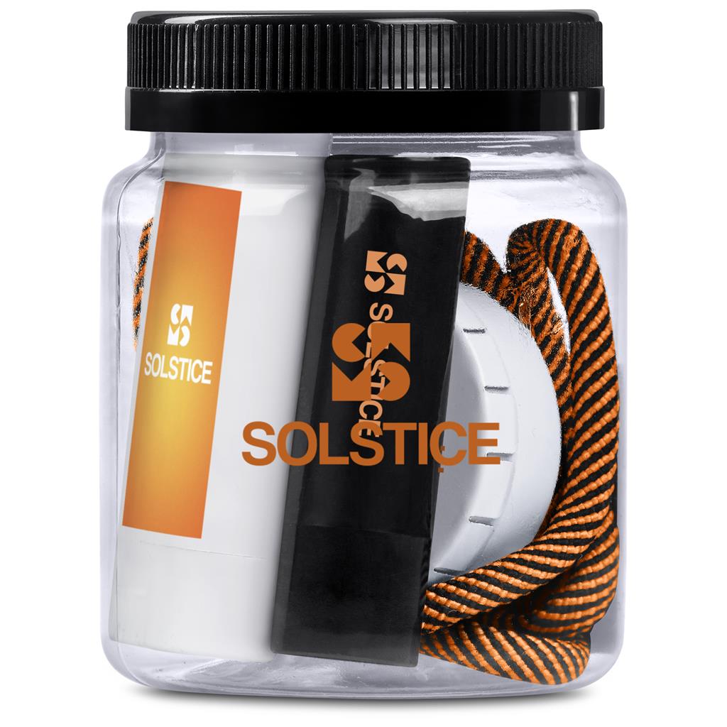 Clear container with Solstice branded items including a black and orange rope, white ball, and black tool.

