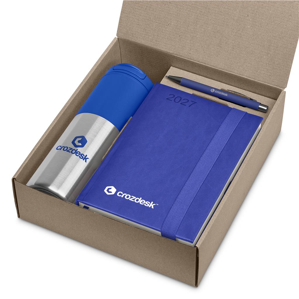 A branded gift set in an open brown cardboard box, featuring a blue and silver stainless steel travel tumbler, a blue 2027 planner, and a matching blue pen with the crozdesk logo.

