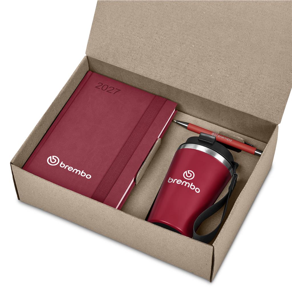 A gift set in an open brown cardboard box containing a 2027 embossed notebook and a matching red travel tumbler with a pen, both branded Brembo.

