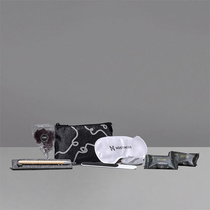Collection of travel items including a pouch, mask, and other products on a gray background

