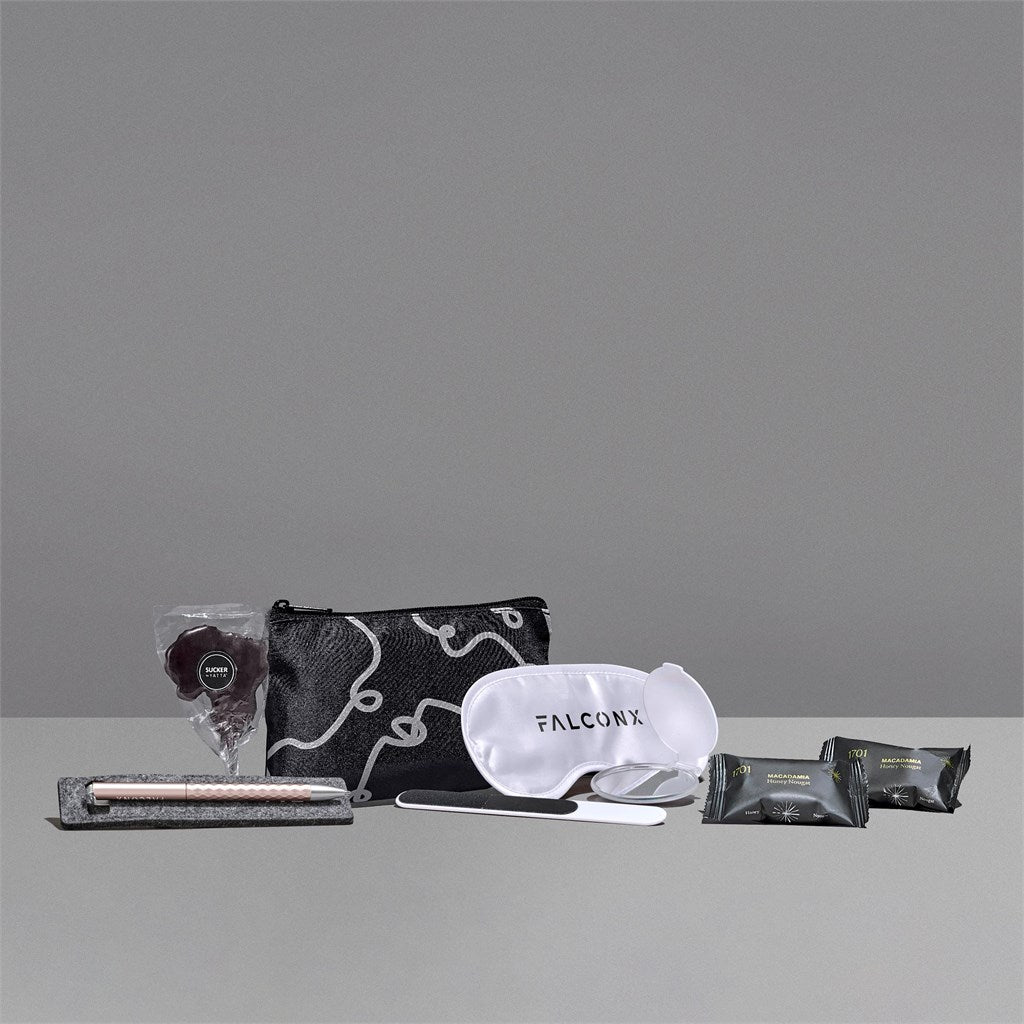 Collection of travel items including a pouch, eye mask, and other products on a gray background with 'FALCONX' branding.


