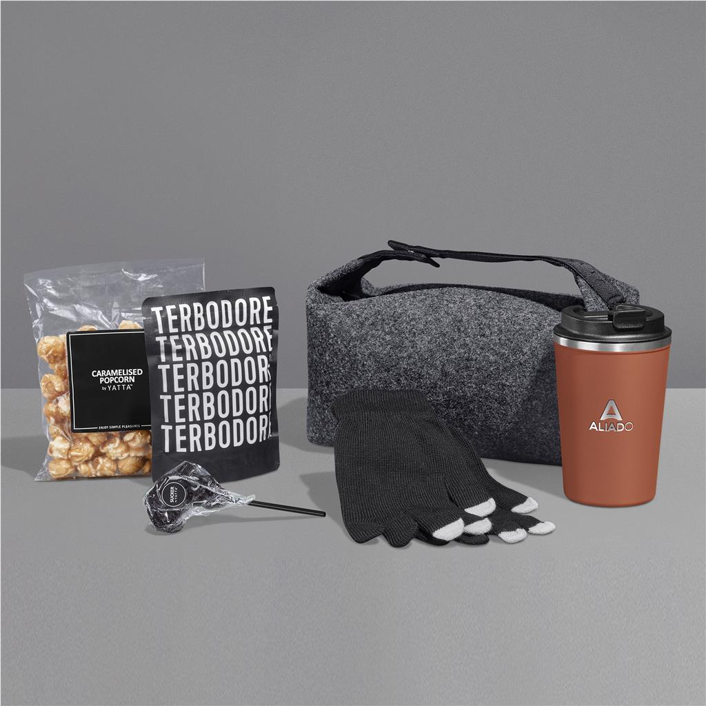 Collection of items including a bag, tumbler, popcorn, and toe shoes on a gray background

