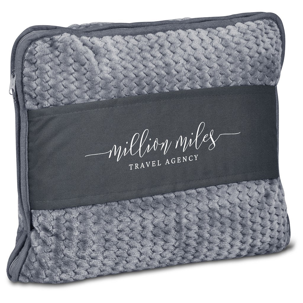 A gray textured travel pillow cover with a dark charcoal band across the center featuring the white printed text 'million miles TRAVEL AGENCY'.

