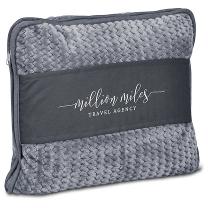A gray textured travel pillow cover with a dark charcoal band across the center featuring the white printed text 'million miles TRAVEL AGENCY'.

