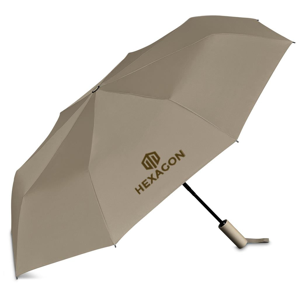 A beige compact folding umbrella with the brand name 'HEXAGON' printed in gold on one of the canopy panels, shown open against a plain white background.

