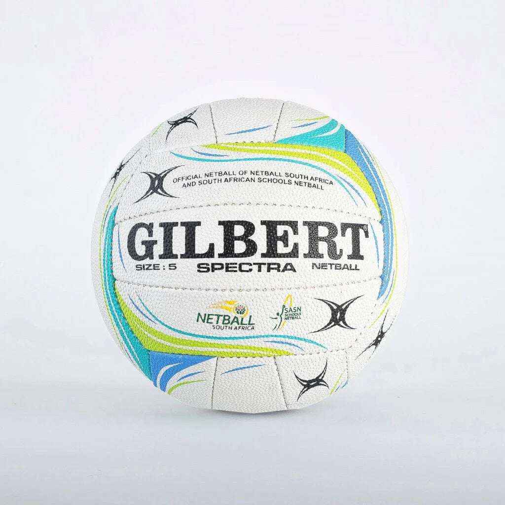 A white Gilbert Spectra netball ball with blue, green, and black graphics, photographed against a plain white background.

