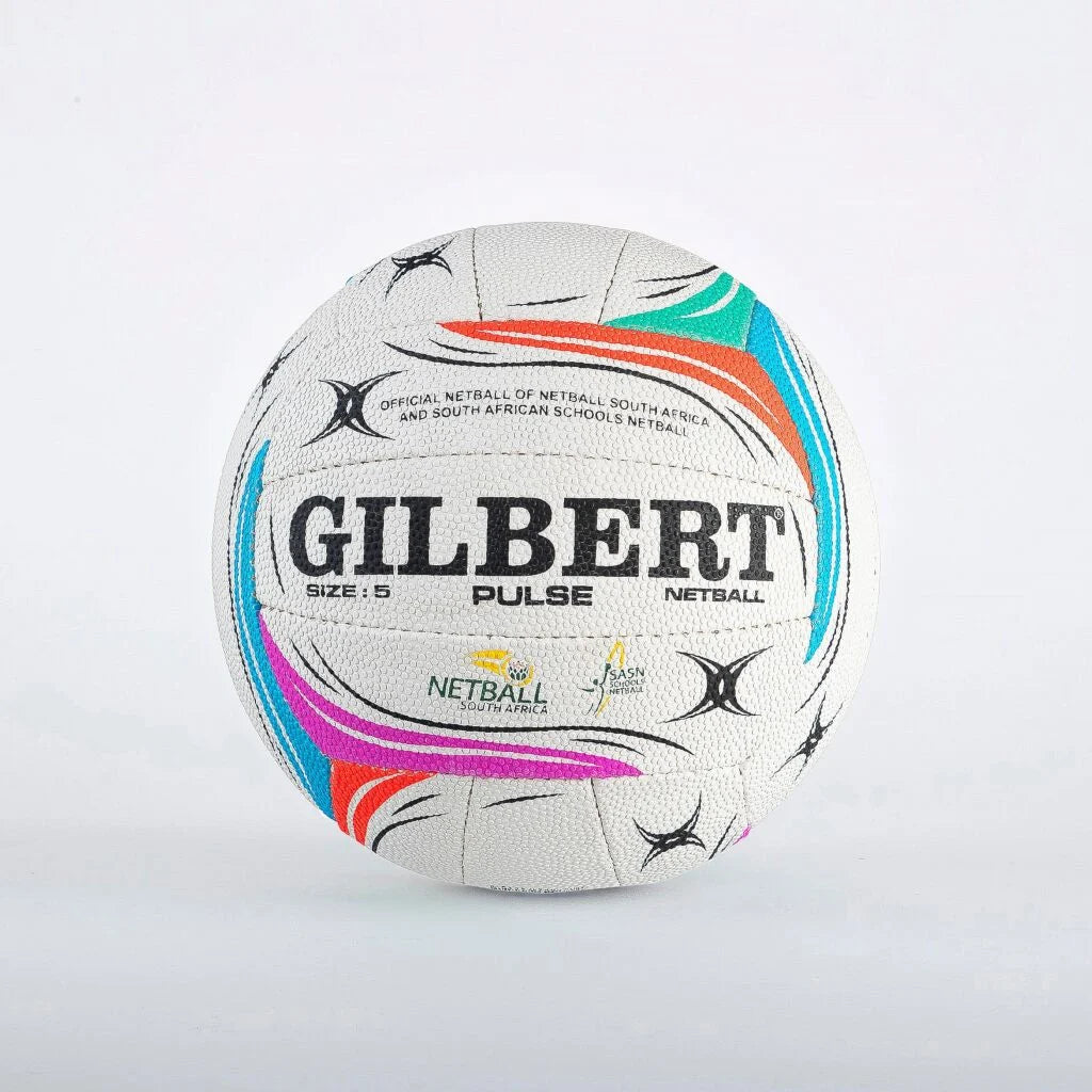 A white Gilbert Pulse netball ball with colorful graphic accents in orange, teal, pink, and blue, featuring black text and logos, set against a plain light gray background.

